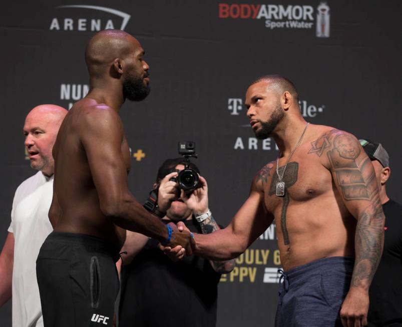 UFC light heavyweights Thiago Santos, right, shakes hands with Jon Jones during weigh ins for U ...