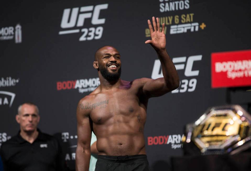 UFC light heavyweight champion Jon Jones waves to his fans during weigh ins for UFC 239 on Frid ...