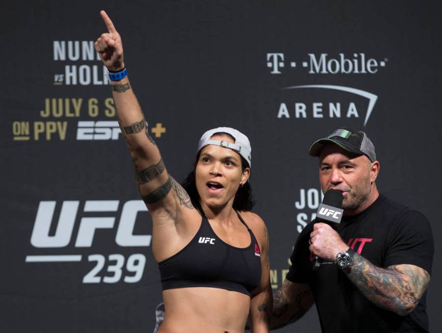 UFC bantamweight champion Amanda Nunes, left, points at her fans while speaking with Joe Rogan ...