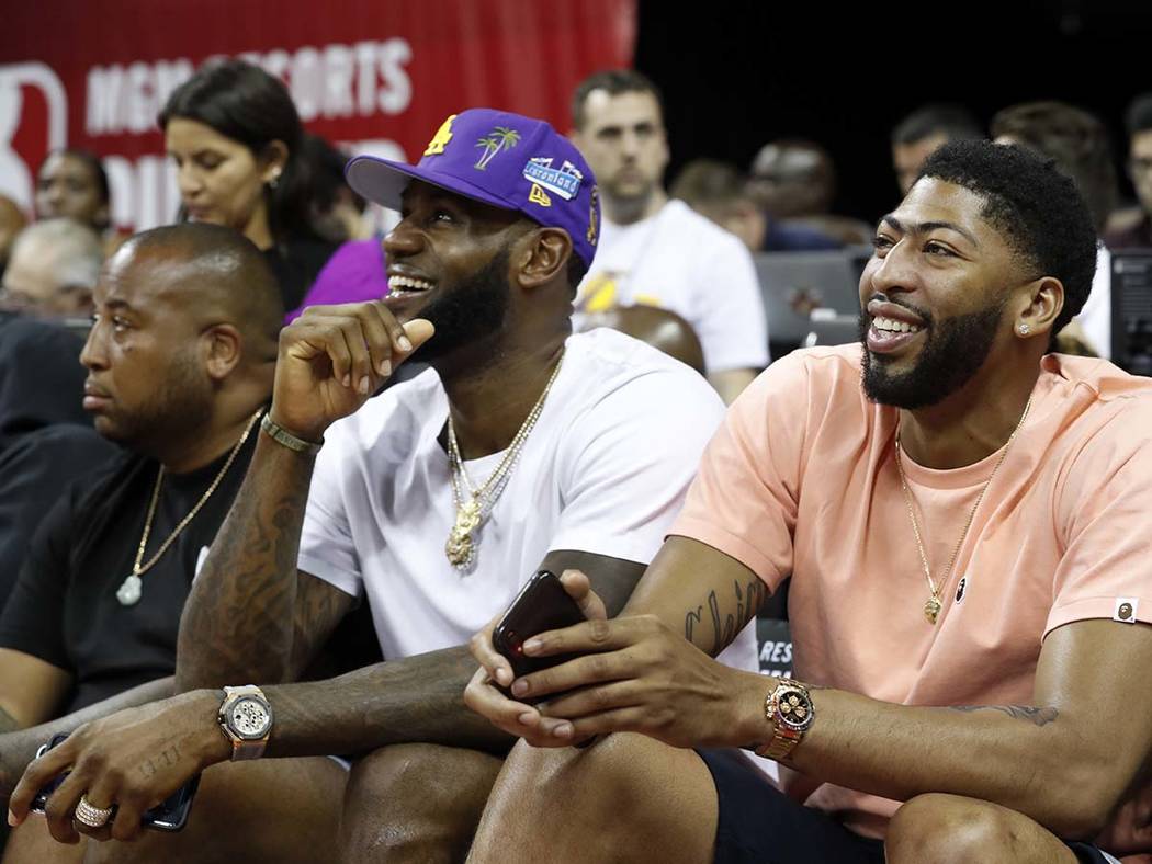 Los Angeles Laker players LeBron James, center, and Anthony Davis take in an NBA Summer League ...