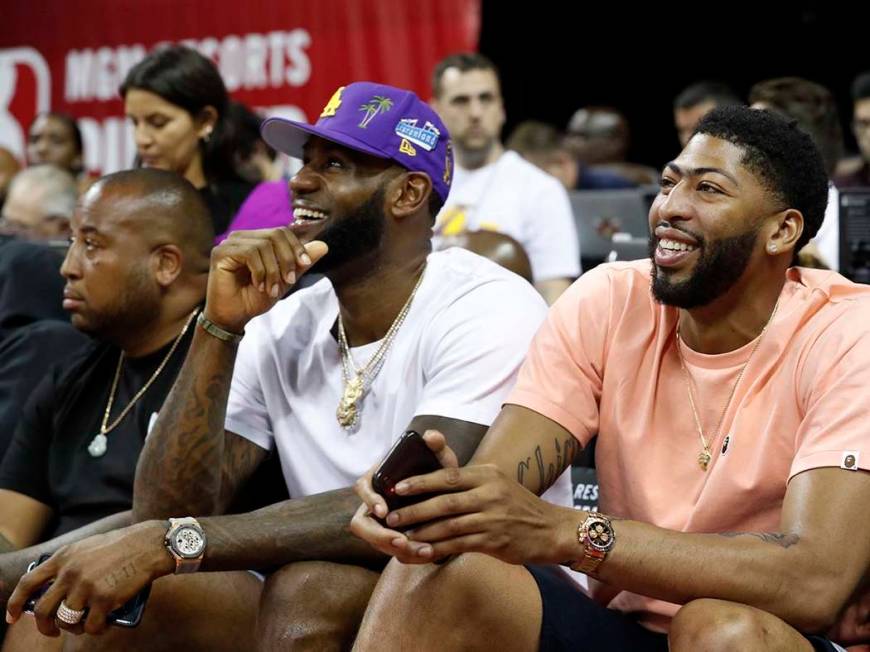 Los Angeles Laker players LeBron James, center, and Anthony Davis take in an NBA Summer League ...