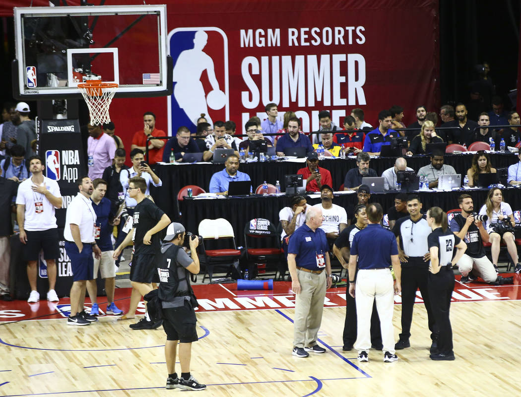 Officials talk after an earthquake stopped a basketball game between the New York Knicks and th ...