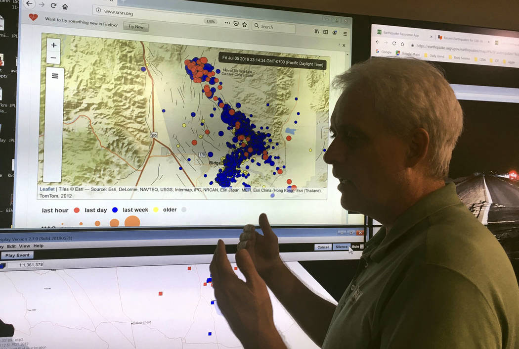 Robert Graves, a seismologist from the U.S. Geological Survey, stands in front of a display of ...