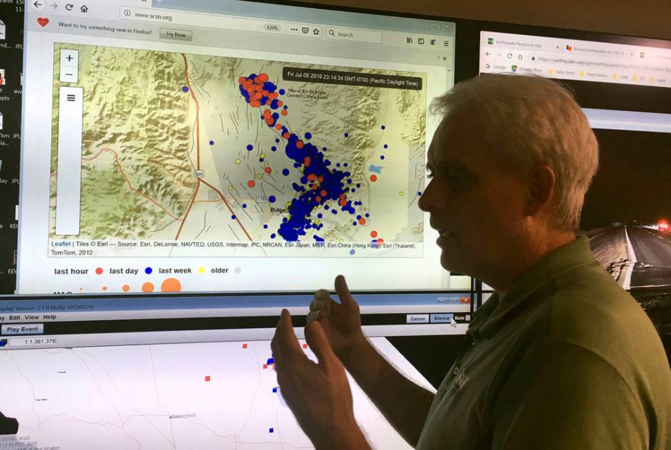 Robert Graves, a seismologist from the U.S. Geological Survey, stands in front of a display of ...