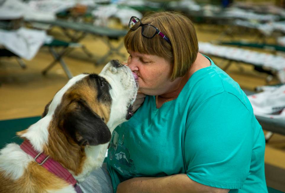 April Hamlin gets kisses from her dog Duchess some crackers while staying at the California Ear ...