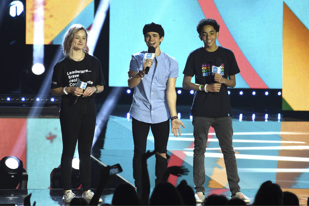 Cameron Boyce speaks at WE Day California, with Macy Lillard, left, and Jazzy Satten at The For ...