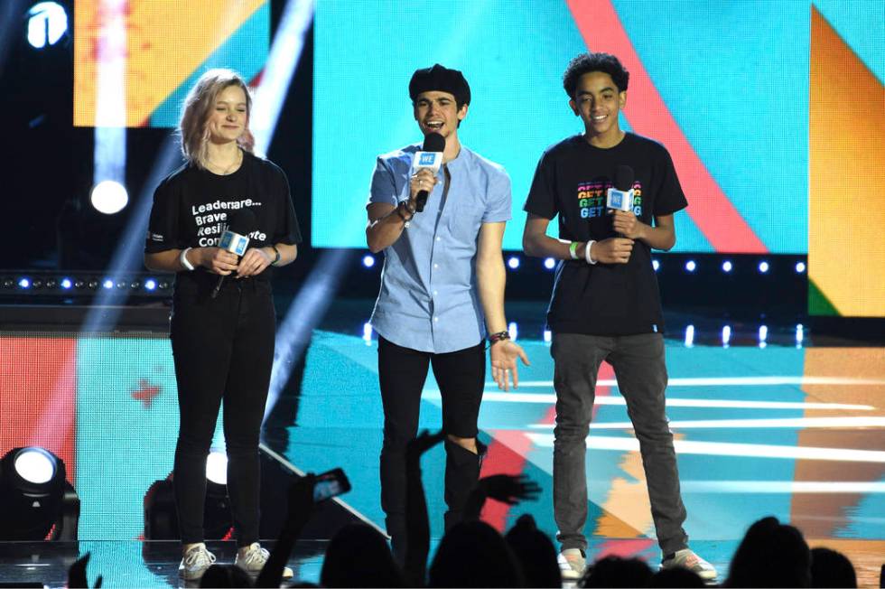 Cameron Boyce speaks at WE Day California, with Macy Lillard, left, and Jazzy Satten at The For ...