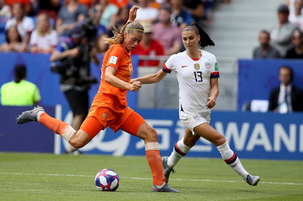 Netherlands' Anouk Dekker, left, is challenged by United States' Emily Sonnett during the Women ...