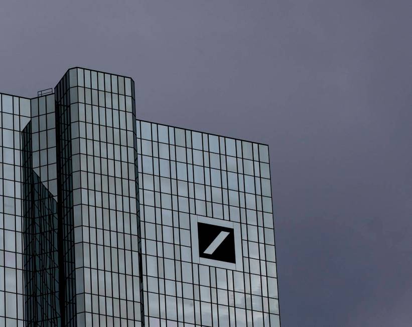 Dark clouds cover the sky over the headquarter of Deutsche Bank in Frankfurt, Germany, Sunday, ...