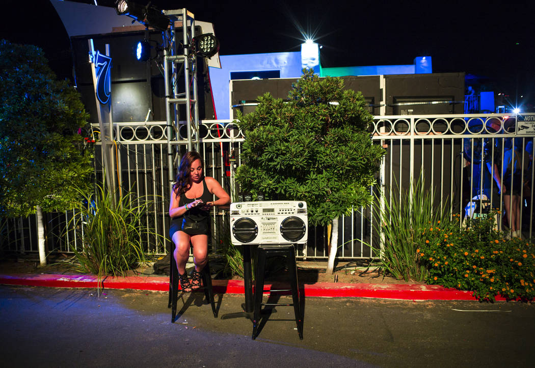 A woman sits next to a boombox during the Jack Daniel's House No. 7, a pop-up experience at the ...