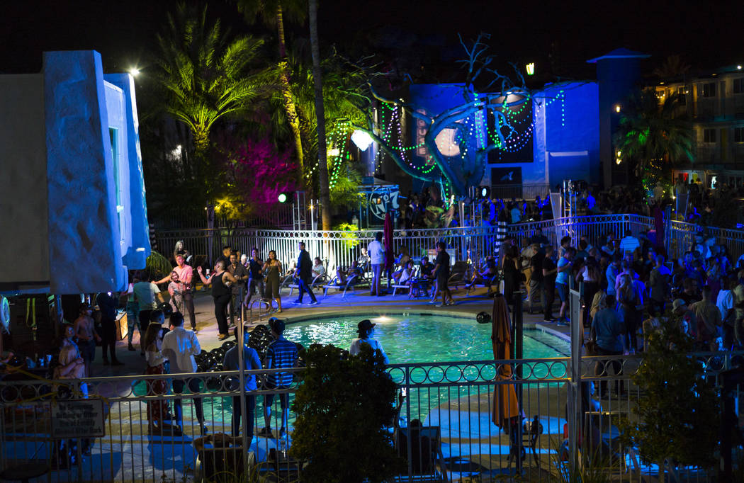 Attendees gather around the pool area for a drag show performance during the Jack Daniel's Hous ...