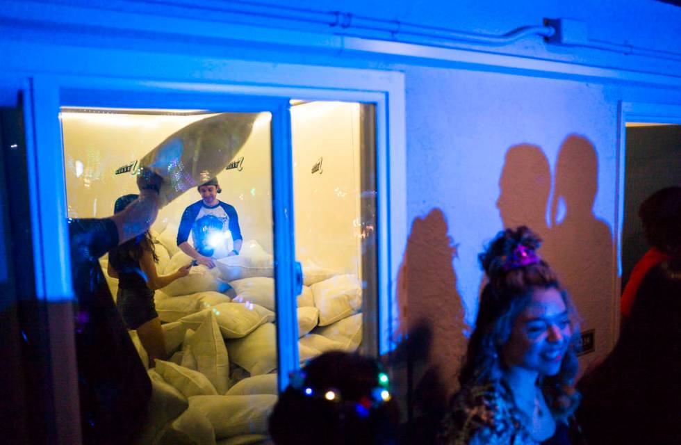 Attendees participate in a pillow fight during the Jack Daniel's House No. 7, a pop-up experien ...