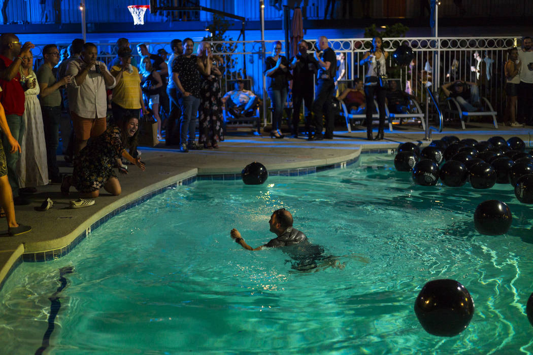 A man swims in the pool during the Jack Daniel's House No. 7, a pop-up experience at the Thunde ...