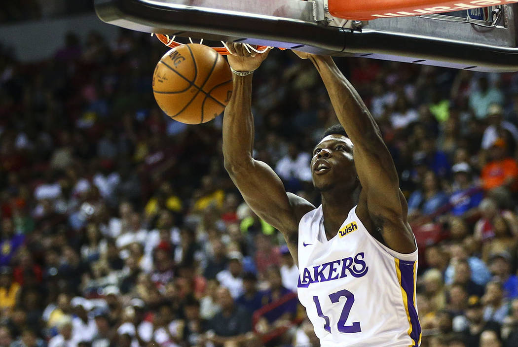 Los Angeles Lakers' Devontae Cacok (12) dunks against the Los Angeles Clippers during the first ...