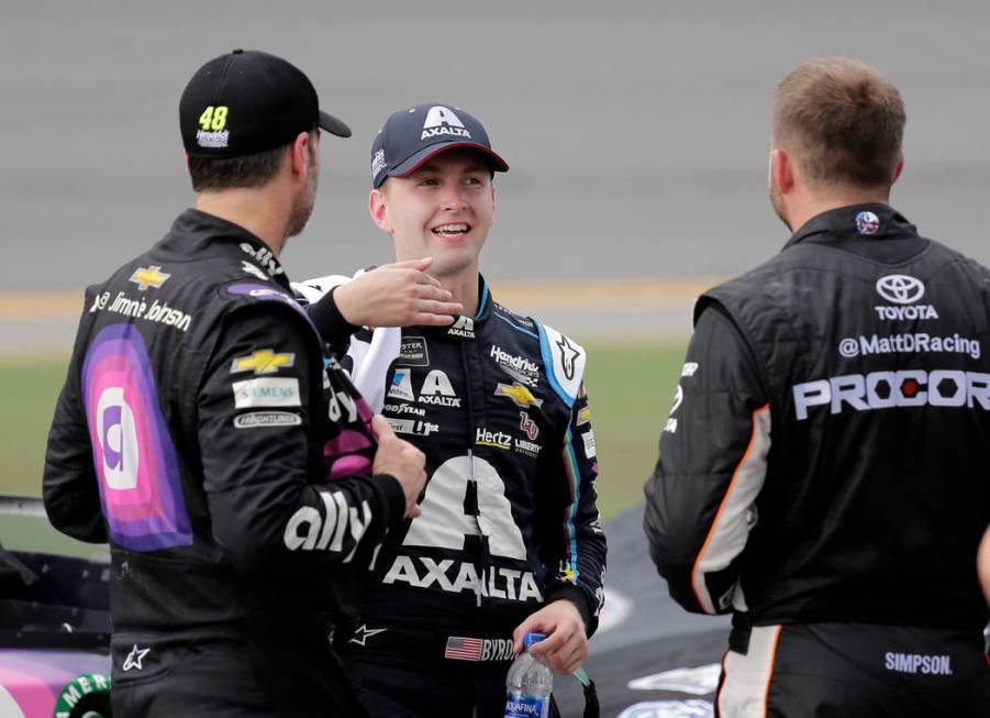 Jimmie Johnson, left, William Byron, center, and Matt DiBenedetto talk on pit road during an in ...