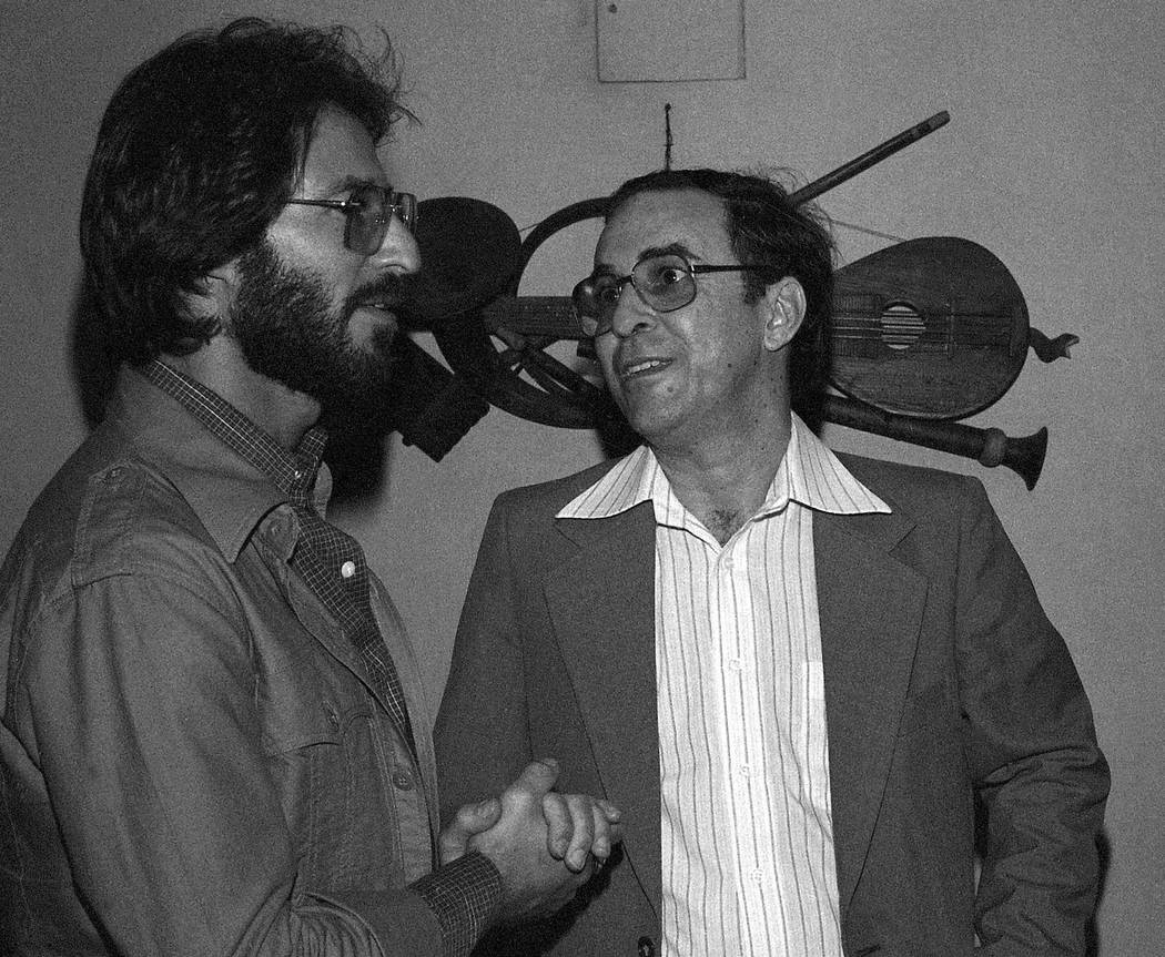 FILE - In this July 1978 file photo, Brazilian Joao Gilberto, right, chats backstage with a fan ...