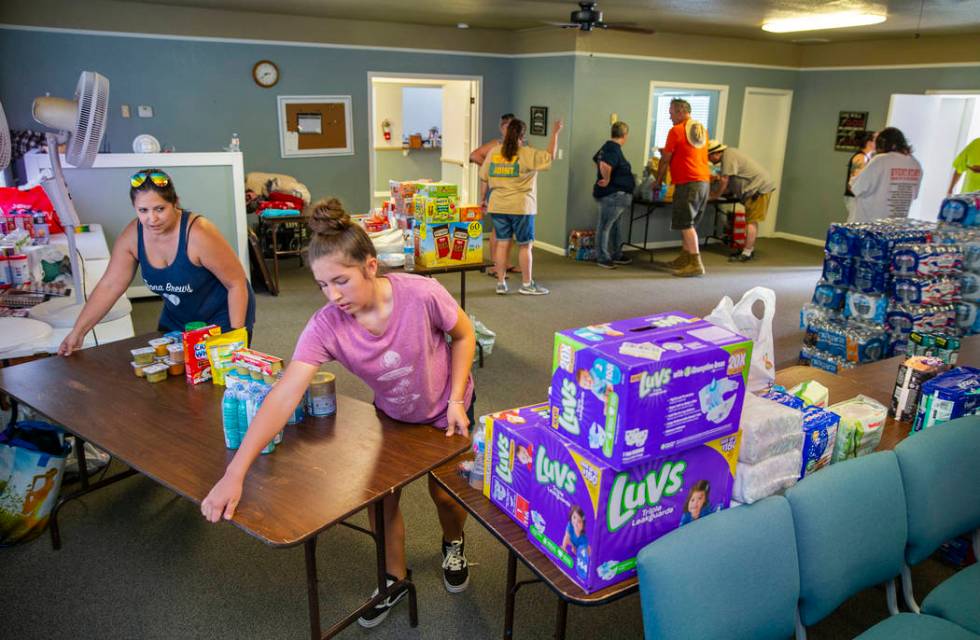 Julia Doss, left, president of the Trona Care, a local community group, and others work to coor ...