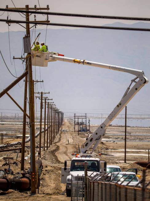 A Southern California Edison crew works to repair the power lines near the Searles Valley Miner ...