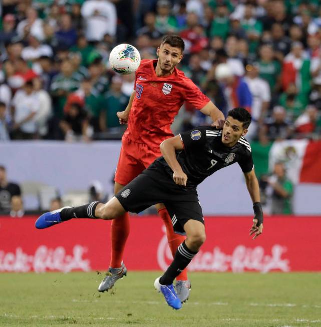 United States defender Matt Miazga, left, and Mexico defender Edson Alvarez battle for the ball ...