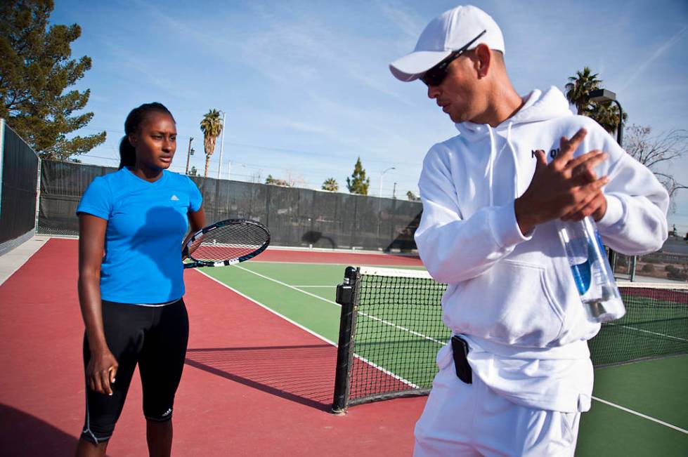 Las Vegas tennis professional Asia Muhammad, left, gets some pointers from her coach, Tim Blenk ...