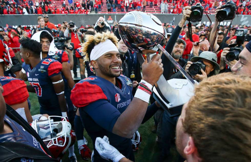 Fresno State quarterback Marcus McMaryion raises the trophy in celebration of his team's win ov ...