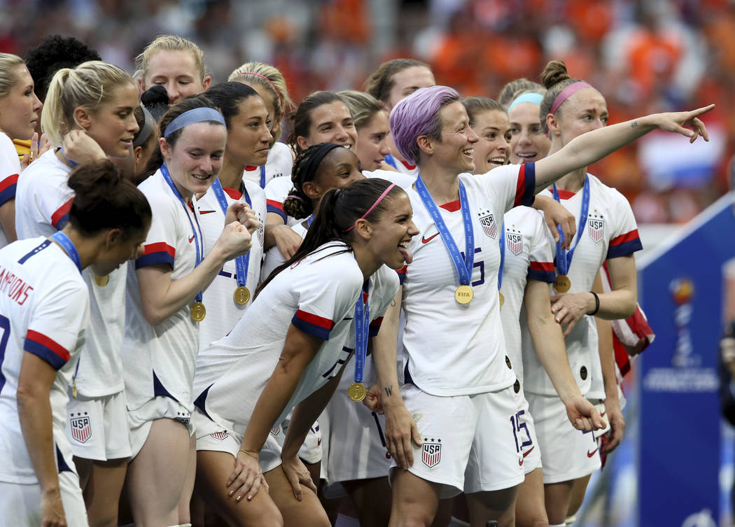 Megan Rapinoe, center, celebrates the U.S. team's victory with teammates after the Women's Worl ...