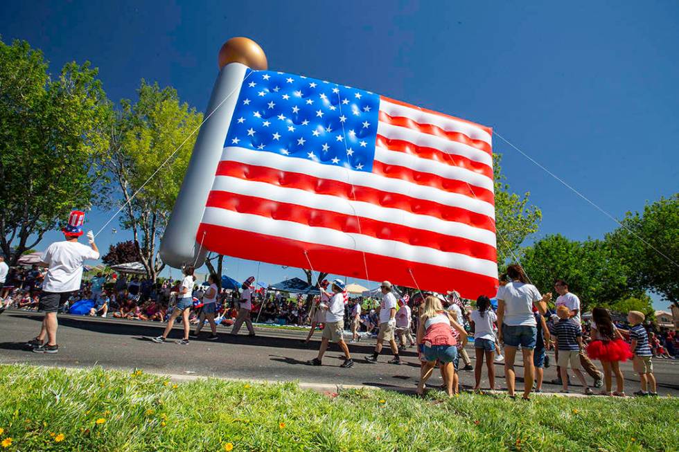 The parade featured traditional floats, giant inflatable balloons, American military heroes, ba ...