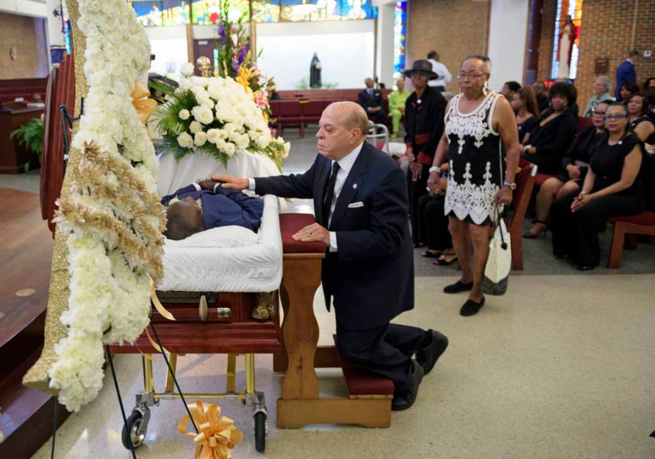 Deacon John Moore touches his friend for the last time during the viewing of Dave Bartholomew a ...