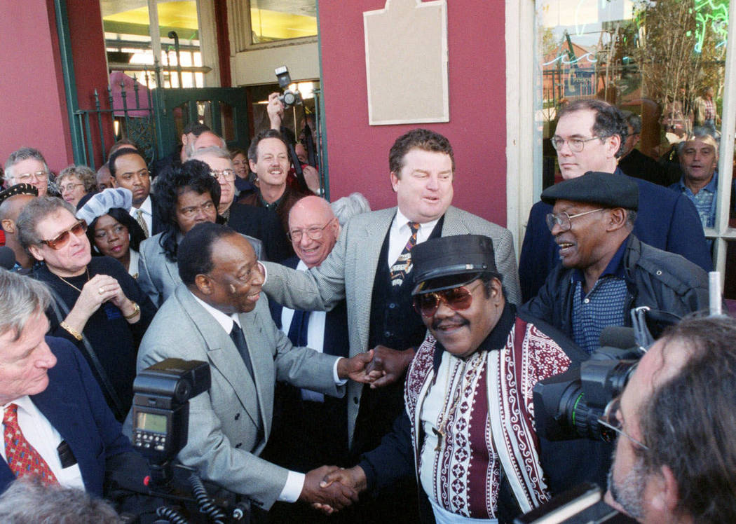 FILE - In a Dec. 10, 1999 file photo, Fats Domino, center right, shakes hands with Dave Barthol ...