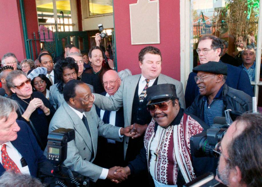 FILE - In a Dec. 10, 1999 file photo, Fats Domino, center right, shakes hands with Dave Barthol ...