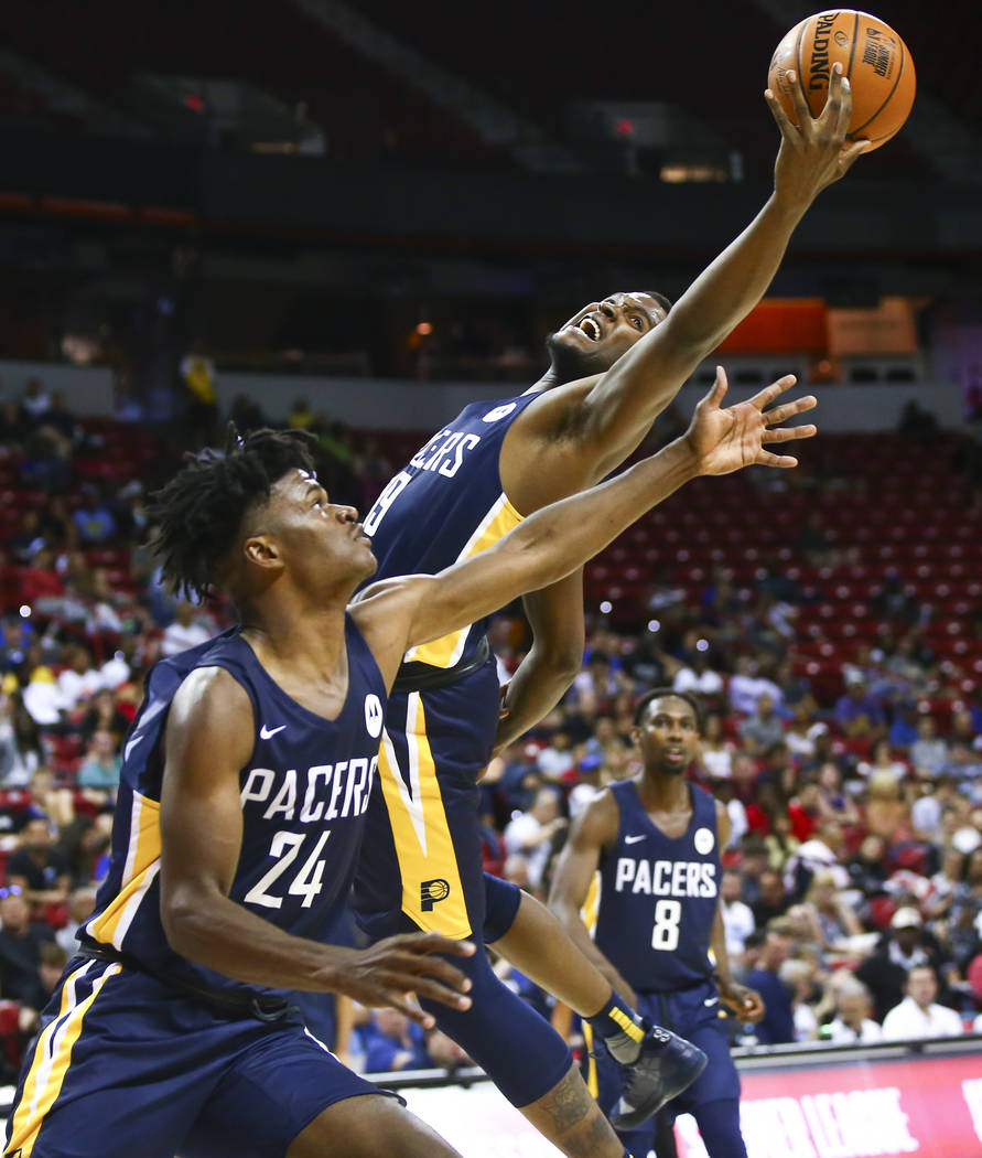 Indiana Pacers' Jaylen Johnson reaches for a rebound over teammate Alize Johnson (24) while pla ...