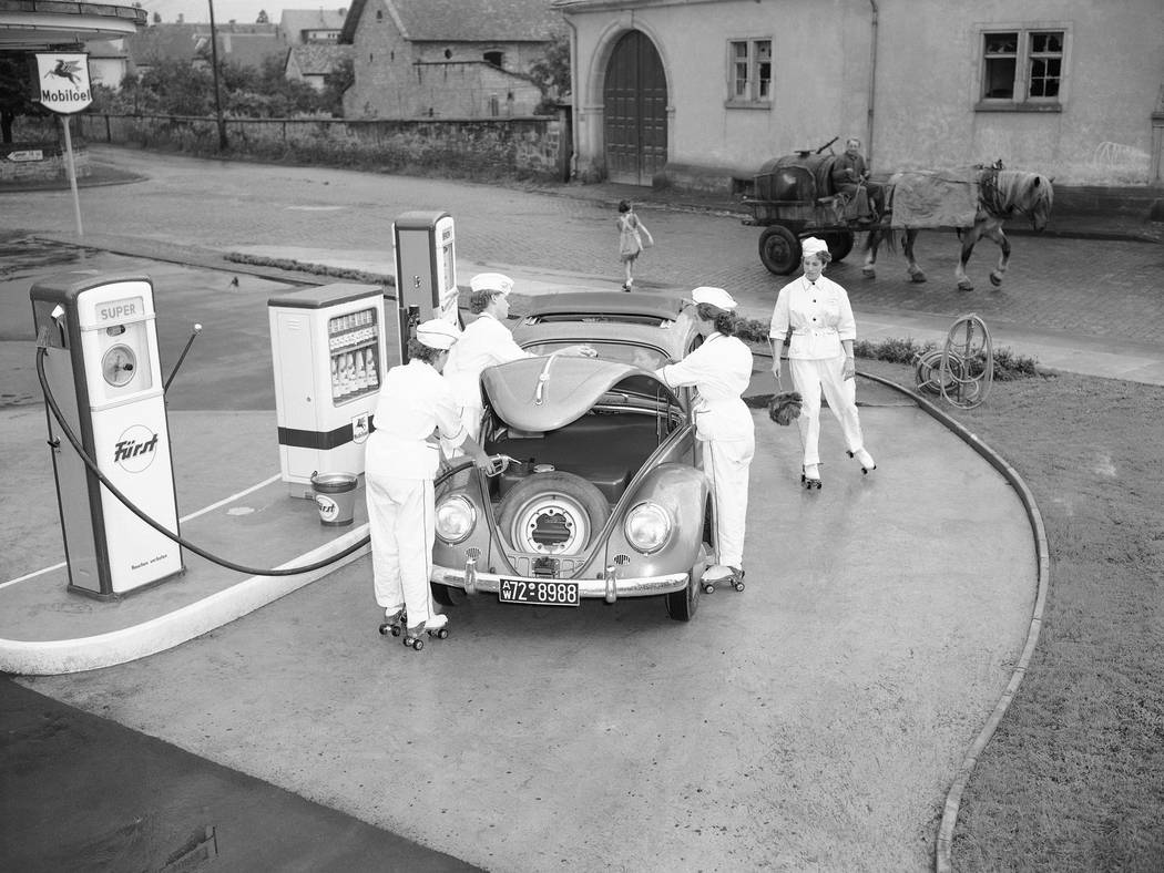 FILE - In this Aug. 23, 1954 file photo, four female employees tend to a Volkswagen at a gas st ...