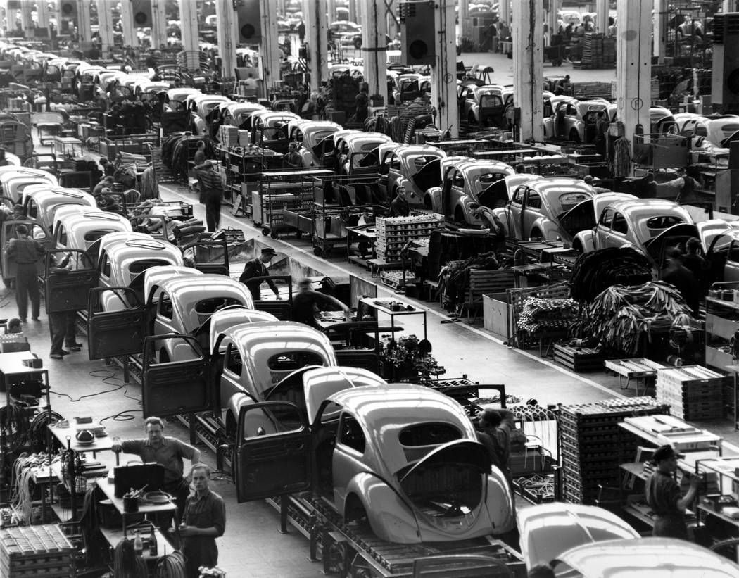 FILE - In this June 16, 1954 file photo, VW beetles are assembled in lines at the Volkwagen aut ...