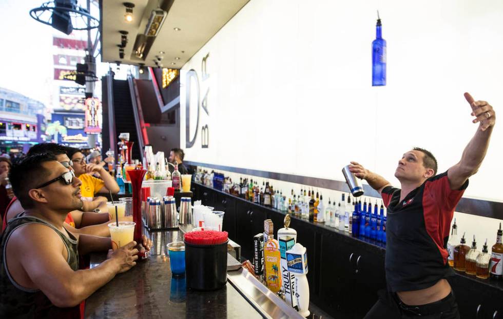 Bartender Kristian Mihailin, right, wows the crowd while making a frozen specialty drink at D B ...