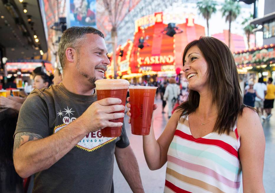 Kevin Thomason, left, and Melissa Bennett celebrate after ordering 32-ounce red beers on Friday ...