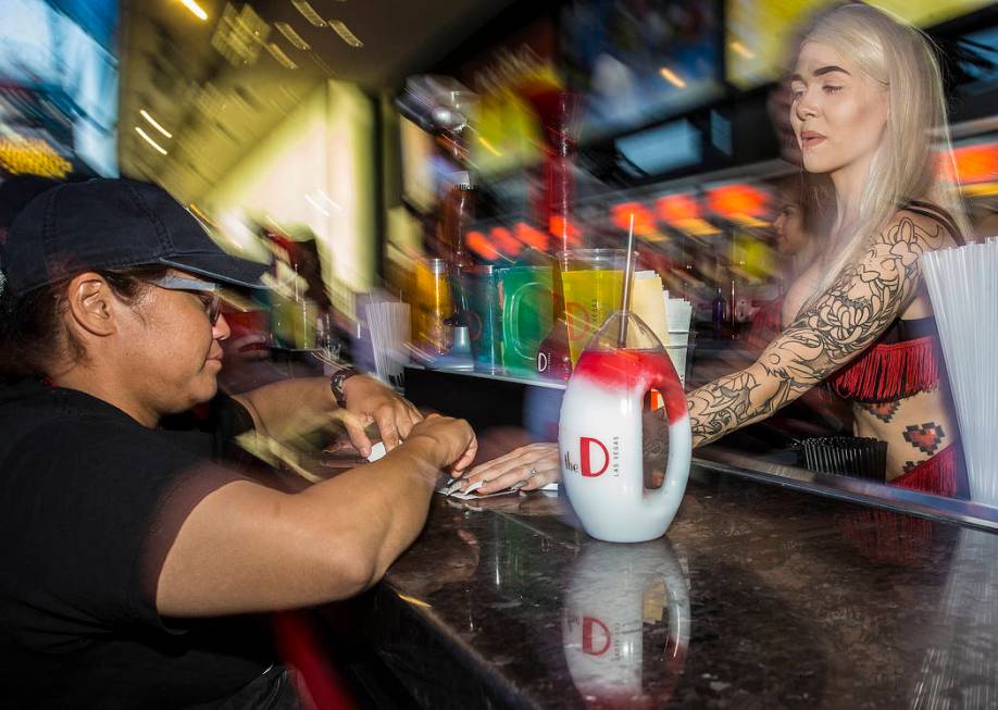 Bartender Hunter Cox, right, serves Kiro Murashige a tropical bliss frozen drink on Friday, Jul ...