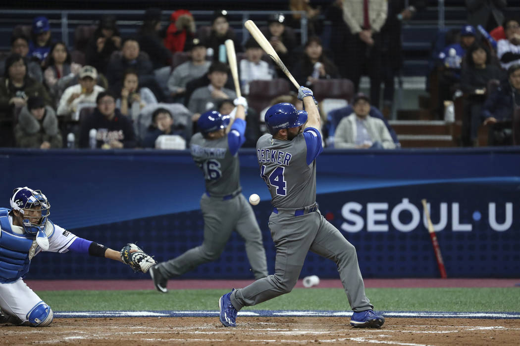Israel's designated hitter Cody Decker, foreground, fouls off a pitch against South Korea durin ...