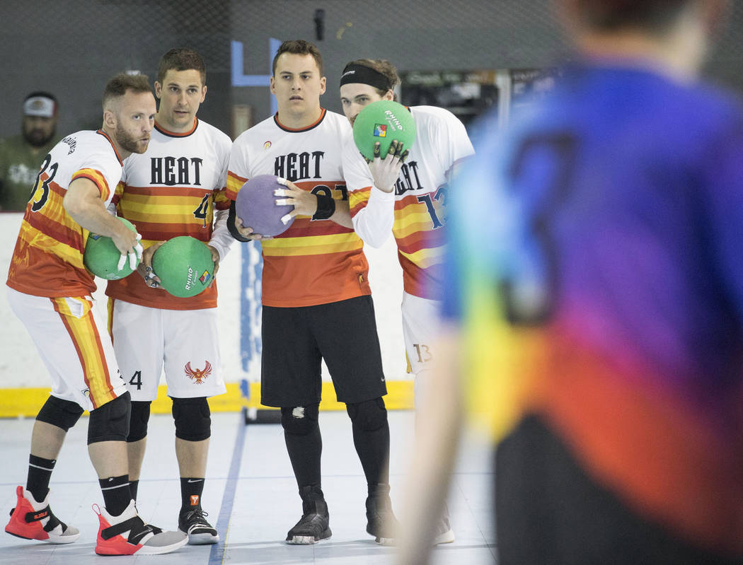 Heat players huddle up before attacking against the Reign Bros during a two-day, five-division ...