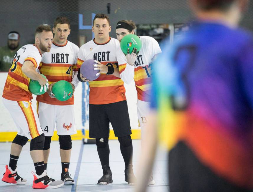 Heat players huddle up before attacking against the Reign Bros during a two-day, five-division ...