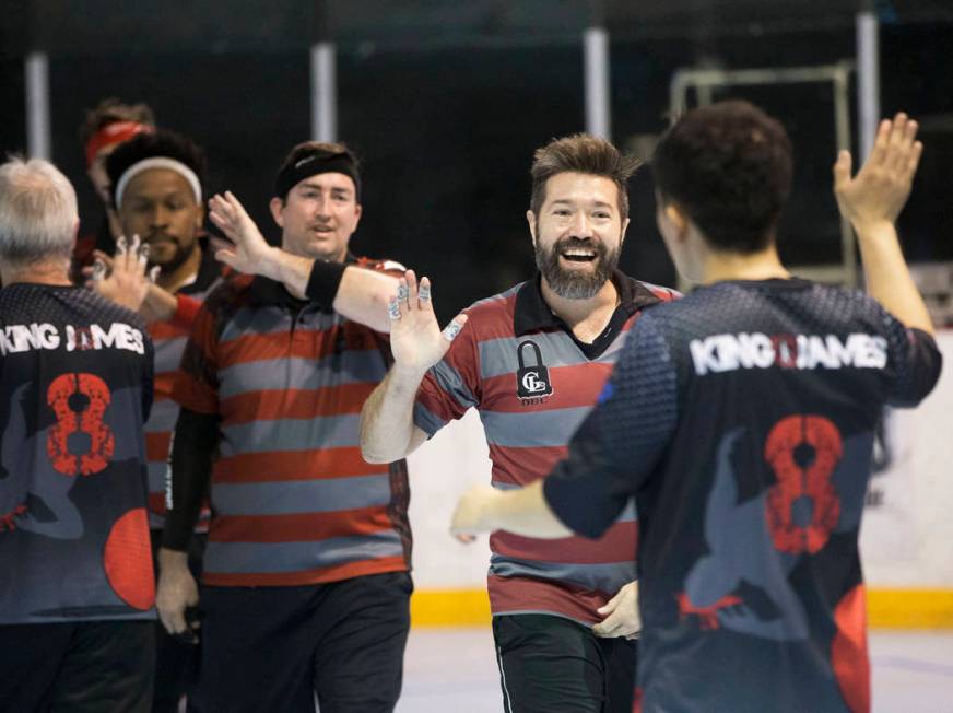 Jake Mason, right/facing, celebrates with team Gridlock during a two-day, five-division dodgeb ...