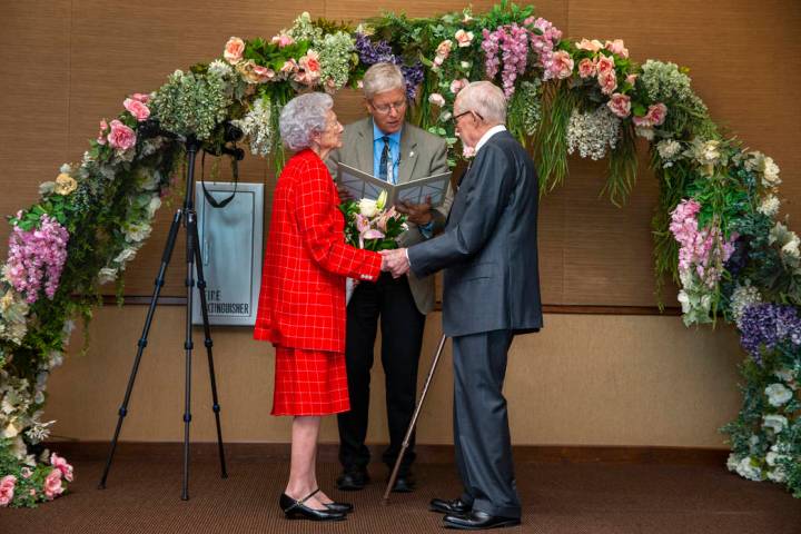 Donna Andress, left, looks to husband Gail, right, as Deacon Tim O'Callaghan presides during a ...