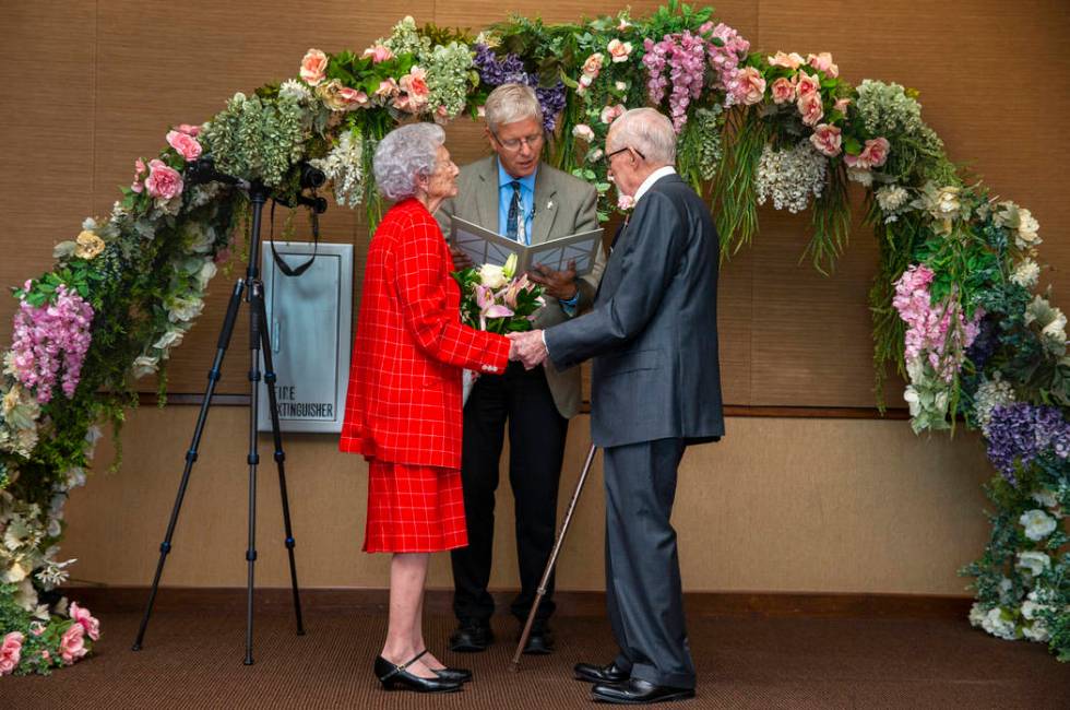 Donna Andress, left, looks to husband Gail, right, as Deacon Tim O'Callaghan presides during a ...