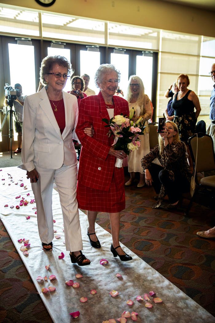 Longtime friend Judy Bundorf, left, walks Donna Andress down the aisle to awaiting husband Gail ...