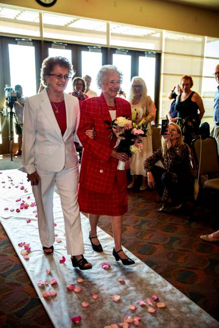 Longtime friend Judy Bundorf, left, walks Donna Andress down the aisle to awaiting husband Gail ...