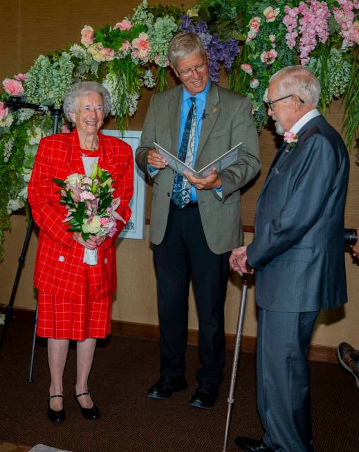 Donna Andress, left, looks to husband Gail, right, as Deacon Tim O'Callaghan presides during a ...