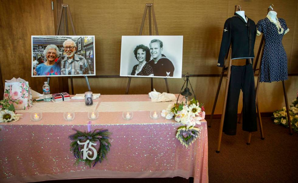 Photos of Gail and Donna Andress and their original wedding outfits on display during a renewal ...