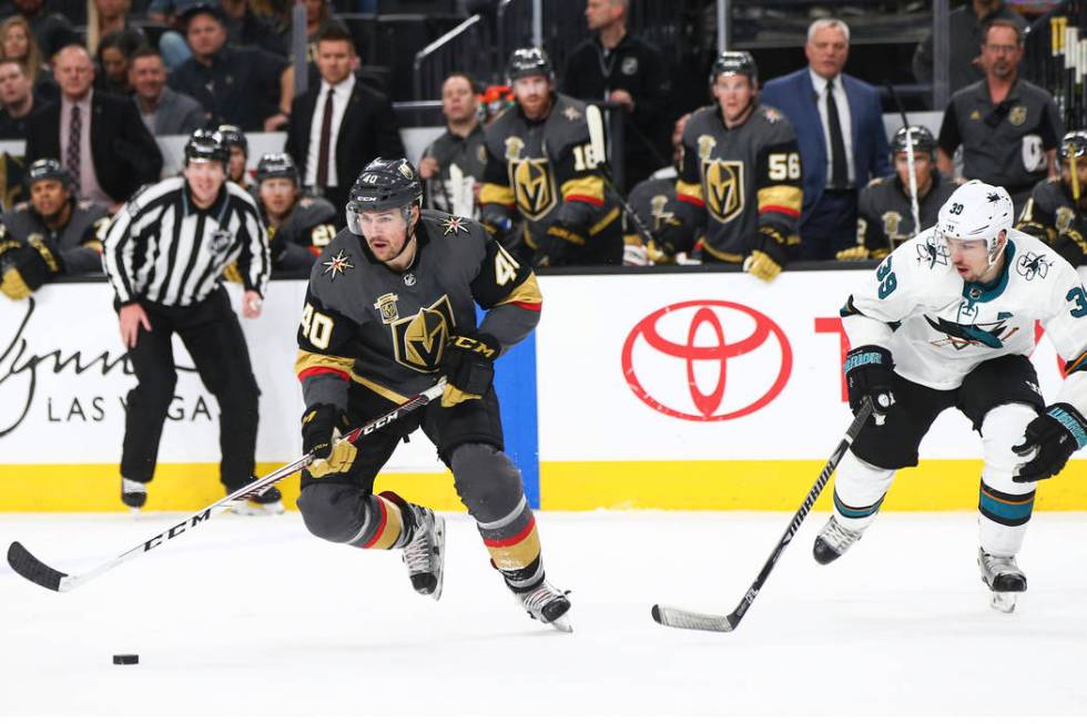 Golden Knights center Ryan Carpenter (40) skates with the puck as San Jose Sharks center Logan ...