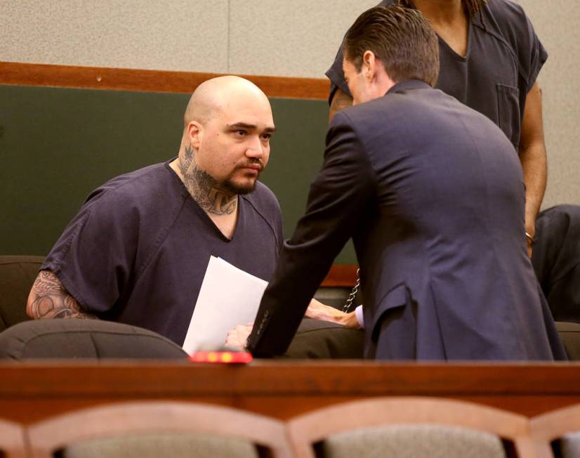 Christopher J. Weygant II, left, talks to his attorney Abel Yanez during a court appearance at ...