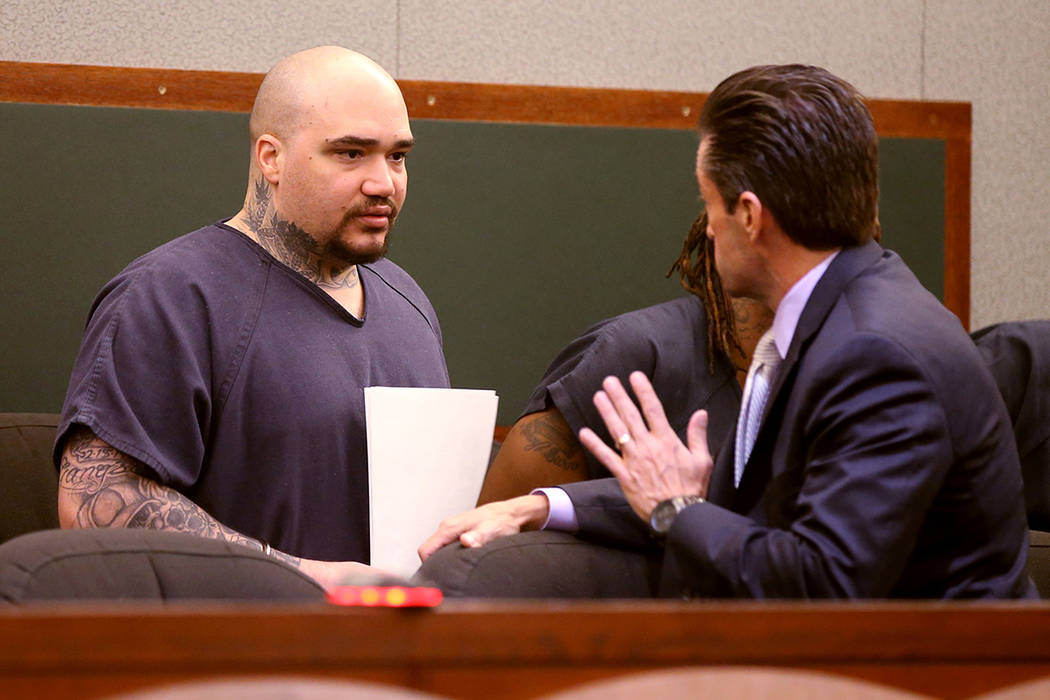 Christopher J. Weygant II, left, talks to his attorney Abel Yanez during a court appearance at ...