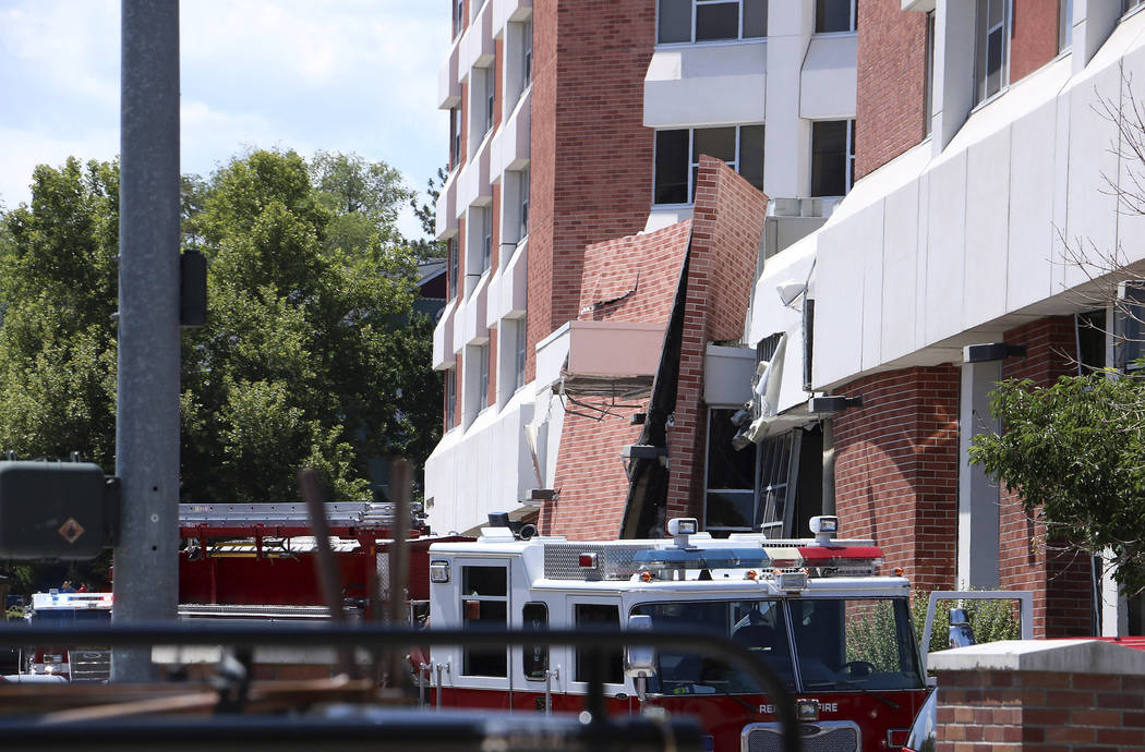 Rescue personnel respond to an explosion that damaged Argenta Hall and Nye Hall on the Universi ...